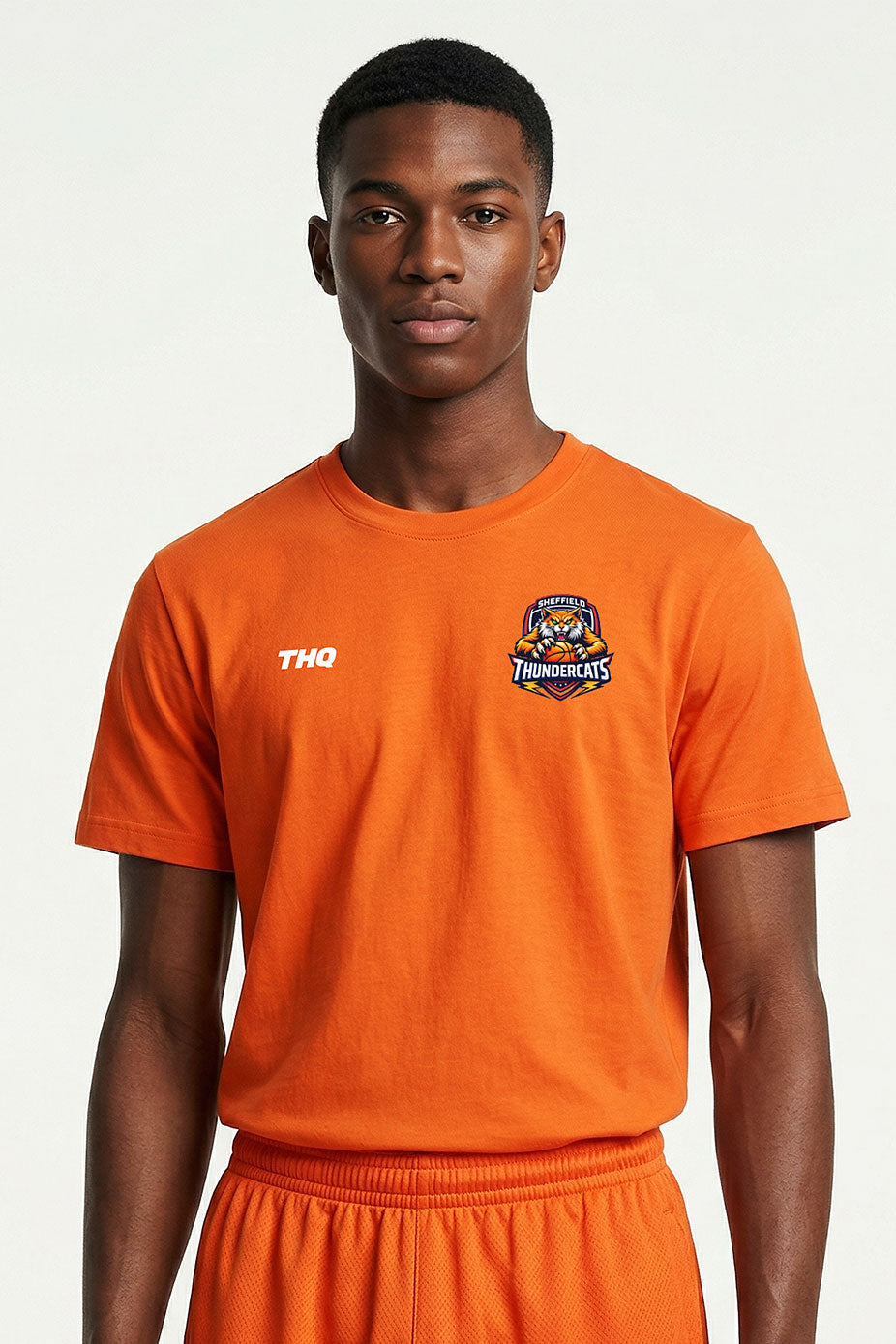 Athlete wearing an orange cotton T-shirt with a THQ logo and Thundercats logo on a white background