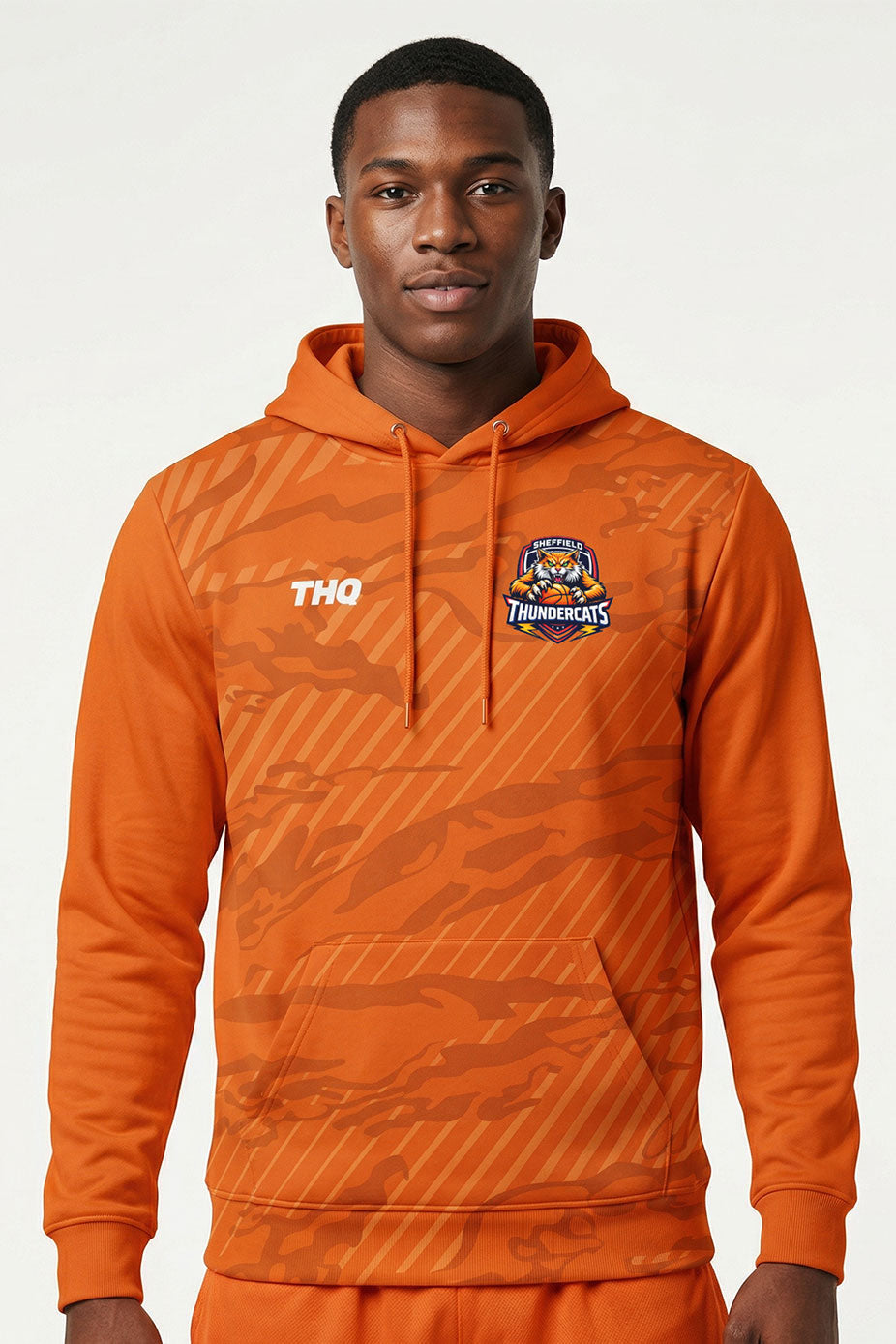 Athlete wearing Orange sublimated performance hoodie with THQ logo and Thundercats logo. 